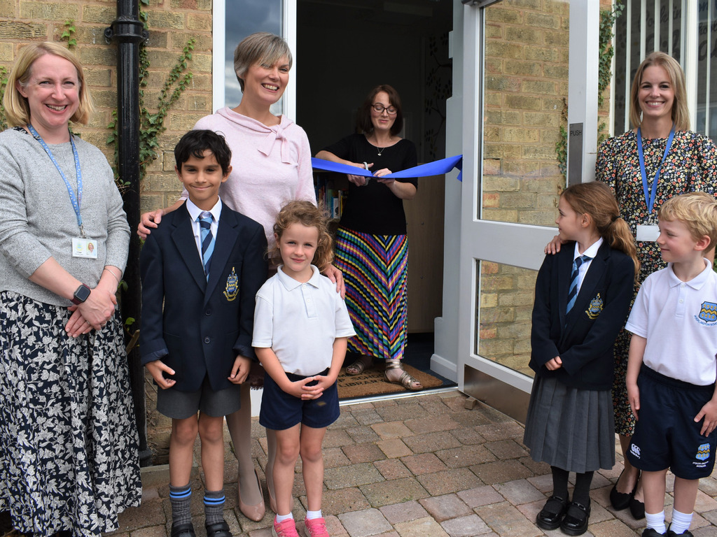 Catherine Jacob cuts the ribbon at Prep School Library.