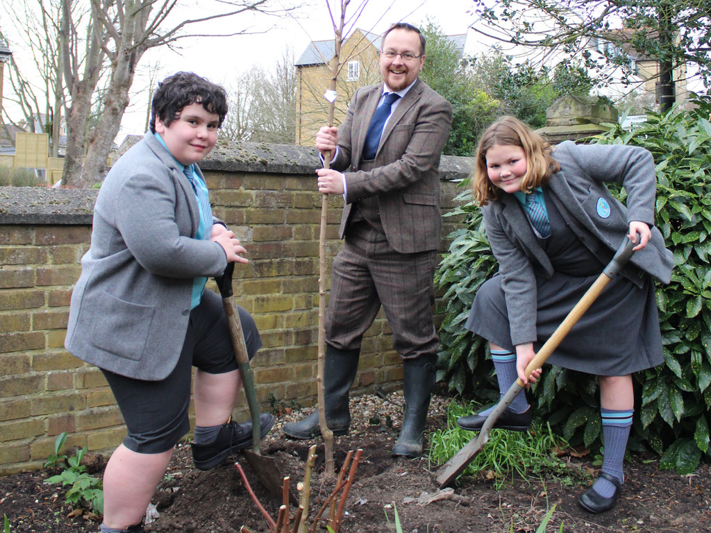 Mr Clarke and Heads of School Planting Tree