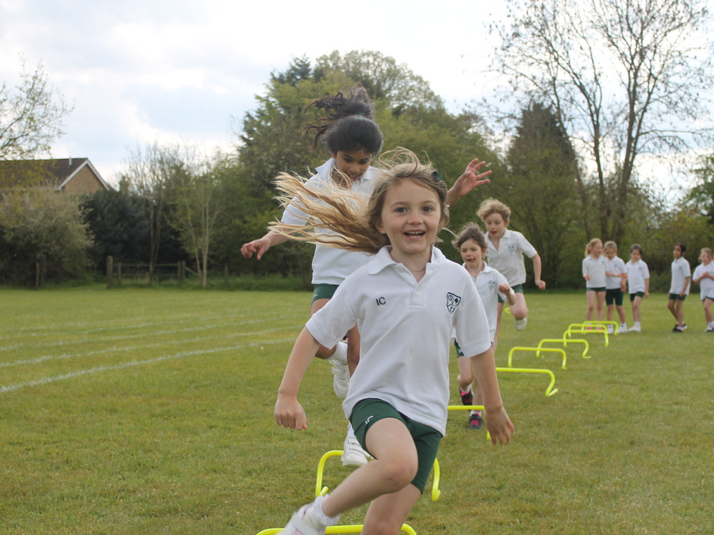 Pre-Prep enjoying their hurdle challenge.